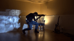 rango playing air guitar with a broom